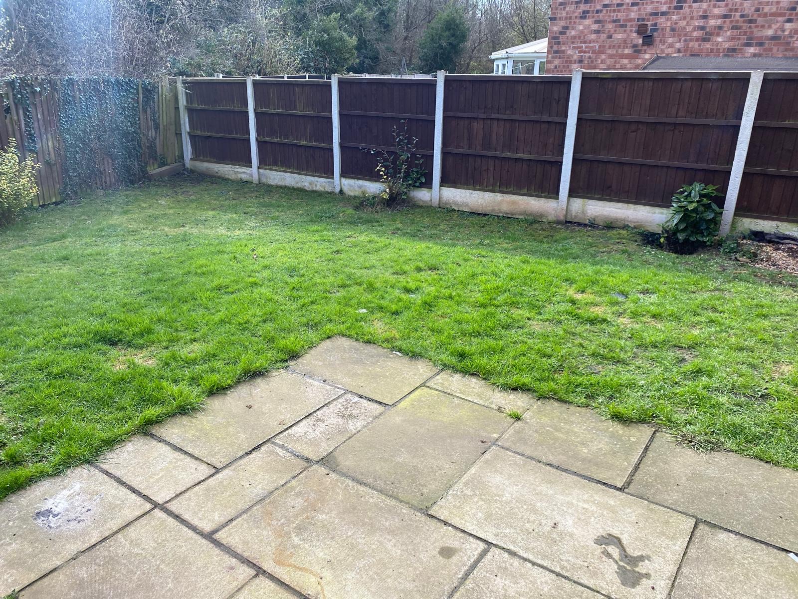 Tired old paving slabs in a back garden before replacement